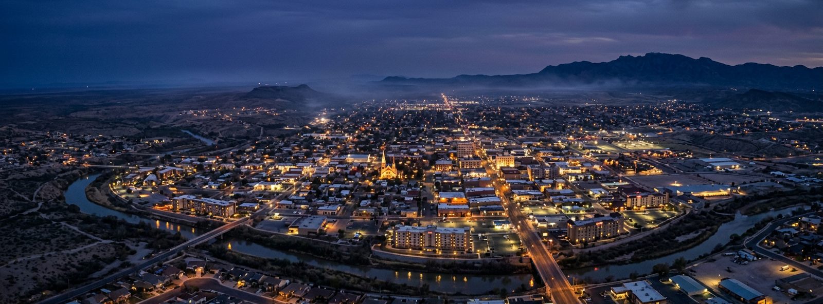 Aerial view of the Carlsbad, New Mexico skyline at dusk, illustrating the metro area TactStack serves structural steel businesses in