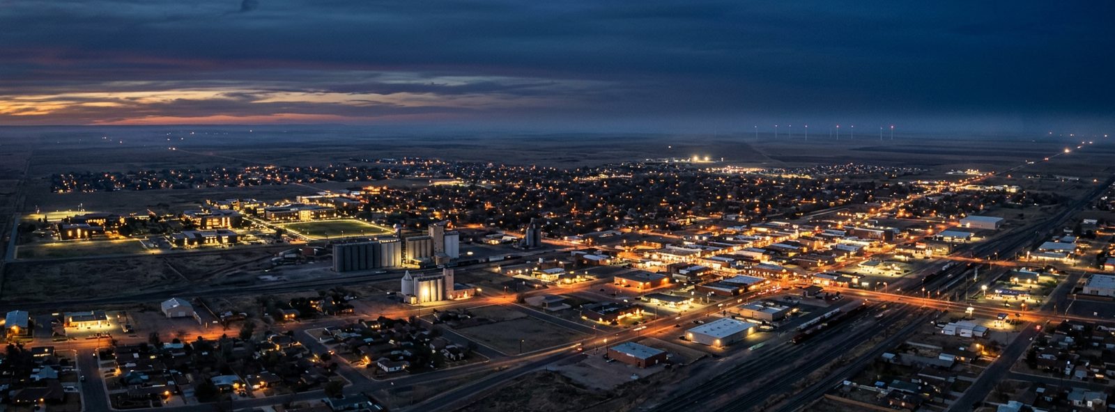 Aerial view of the Clovis, New Mexico skyline at dusk, illustrating the metro area TactStack serves structural steel businesses in