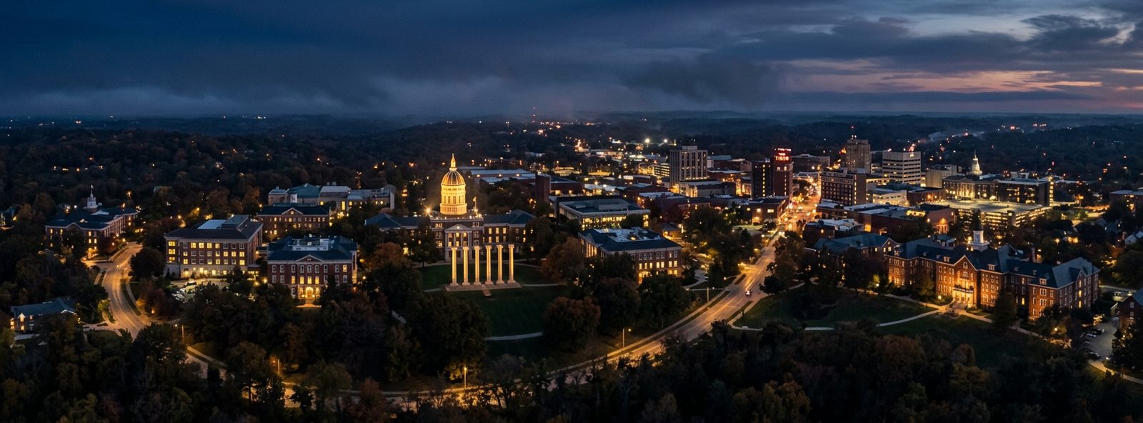 Aerial view of the Columbia, Missouri skyline at dusk, illustrating the metro area TactStack serves structural steel businesses in