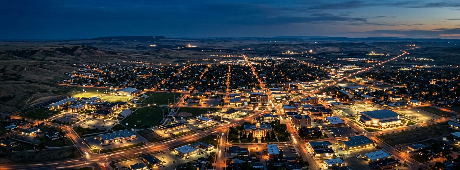 Aerial view of the Gillette, Wyoming skyline at dusk, illustrating the metro area TactStack serves structural steel businesses in
