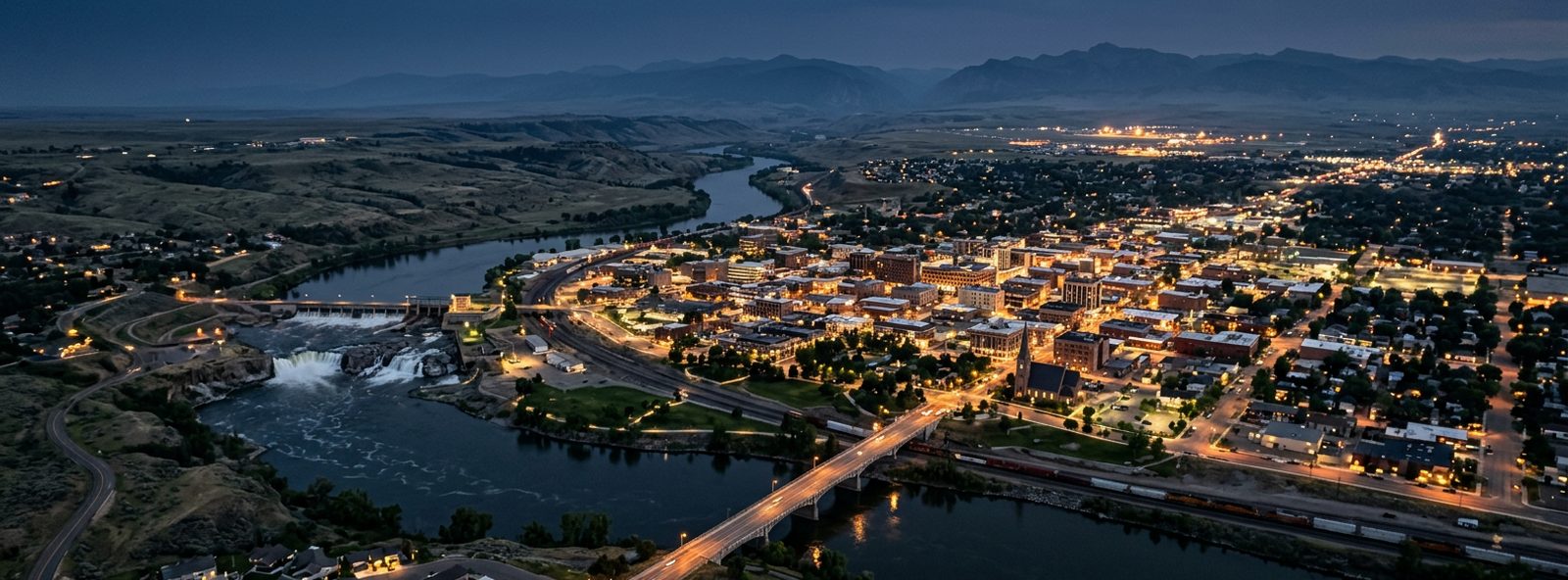 Aerial view of the Great Falls, Montana skyline at dusk, illustrating the metro area TactStack serves structural steel businesses in
