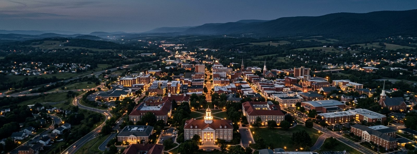 Aerial view of the Harrisonburg, Virginia skyline at dusk, illustrating the metro area TactStack serves structural steel businesses in
