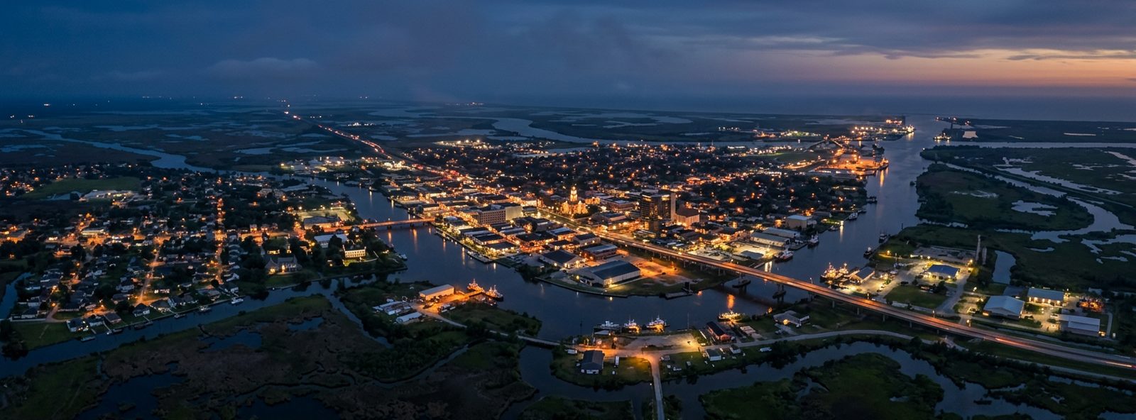 Aerial view of the Houma, Louisiana skyline at dusk, illustrating the metro area TactStack serves structural steel businesses in