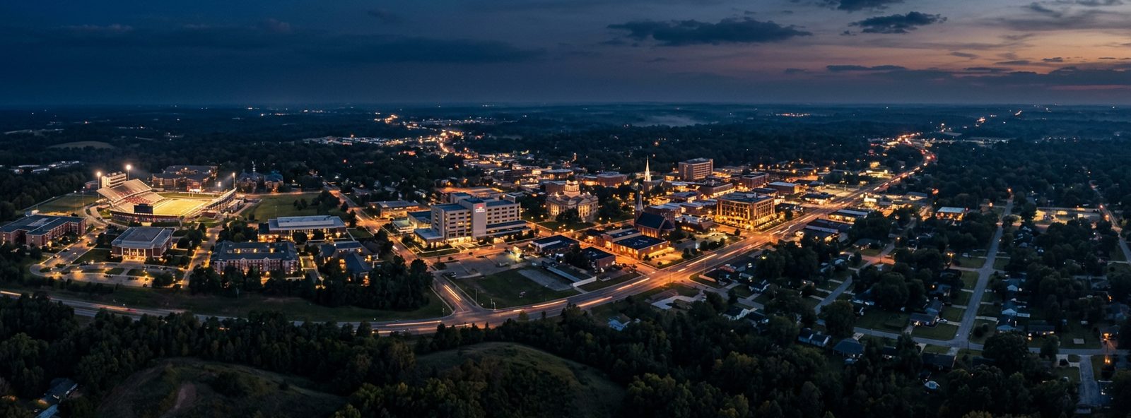 Aerial view of the Jonesboro, Arkansas skyline at dusk, illustrating the metro area TactStack serves structural steel businesses in