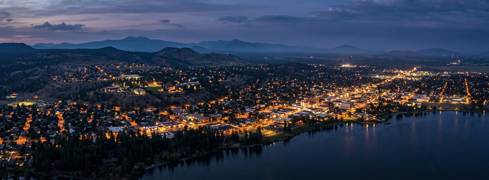 Aerial view of the Klamath Falls, Oregon skyline at dusk, illustrating the metro area TactStack serves structural steel businesses in
