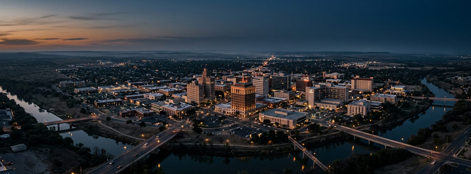 Aerial view of the San Angelo, Texas skyline at dusk, illustrating the metro area TactStack serves structural steel businesses in
